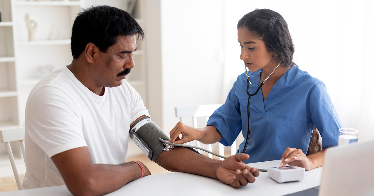 doctor checking man's blood pressure