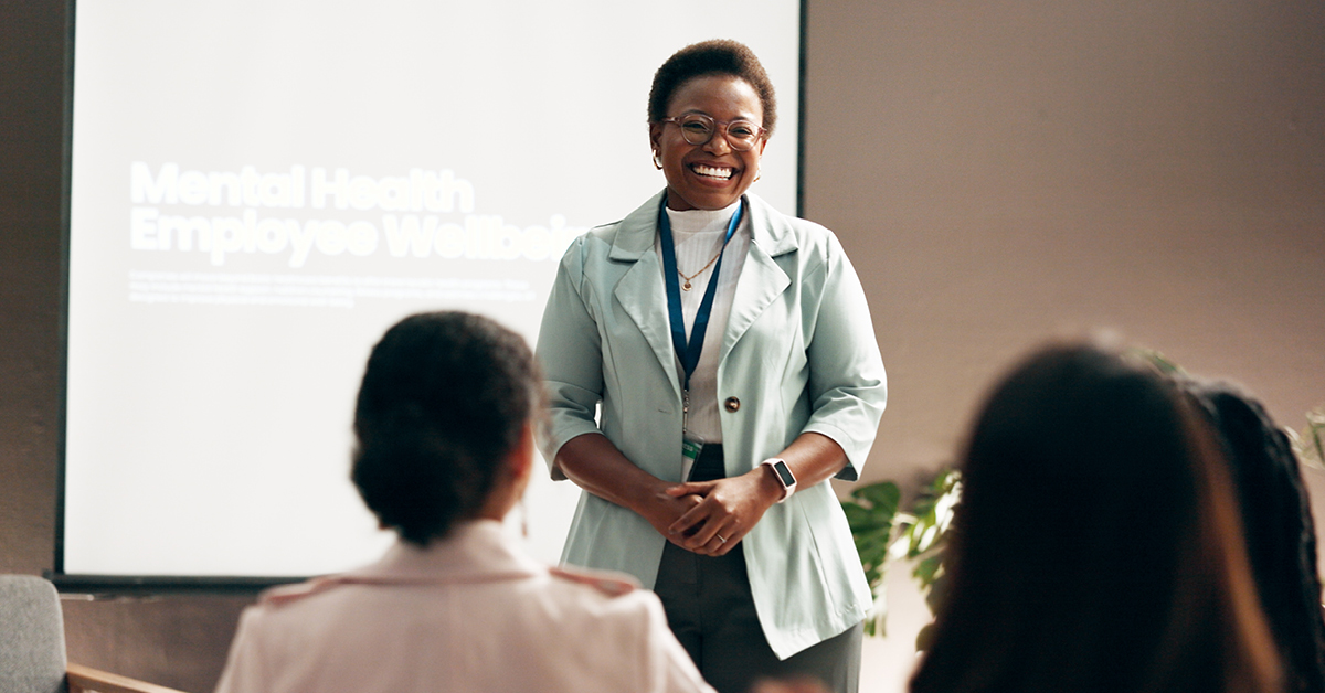 woman speaking in front of a seminar