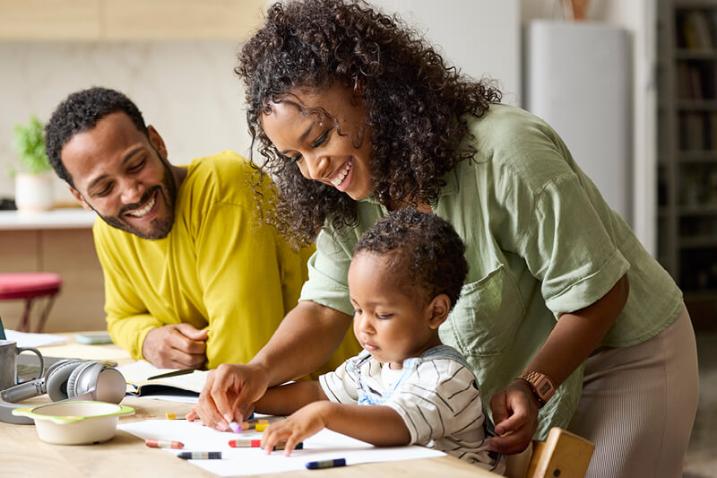 Couple with a child sitting at a table