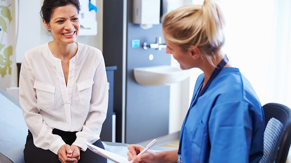 woman meeting with provider in doctors office