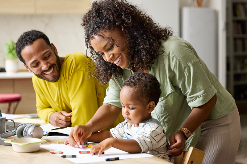Couple with a child sitting at a table