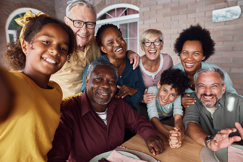 Multiple people smiling for a selfie