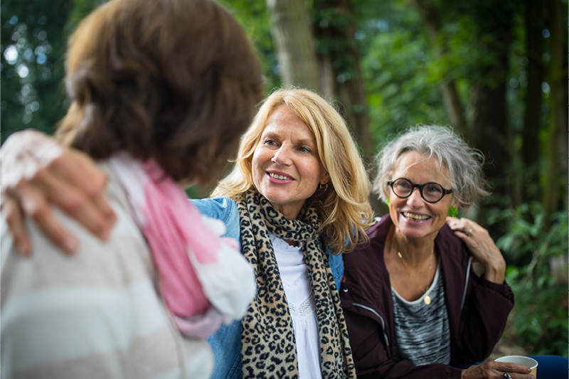 Group of women smiling at one another